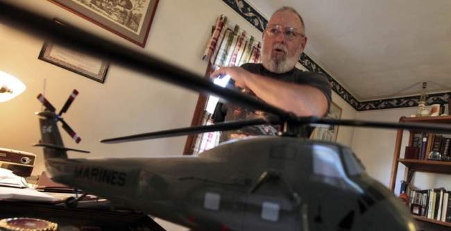 Donat "Dan" LeBlanc a veteran of the Vietnam War, talks about the mission that cost him his arm when he was a gunner aboard a YZ64 hellicopter like the model in the foreground.