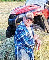 A person sitting on a stack of hay

AI-generated content may be incorrect.